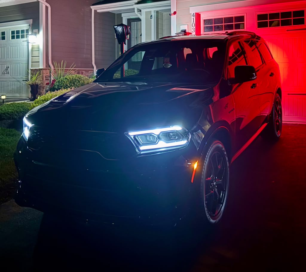 Black SUV detailed and illuminated at night